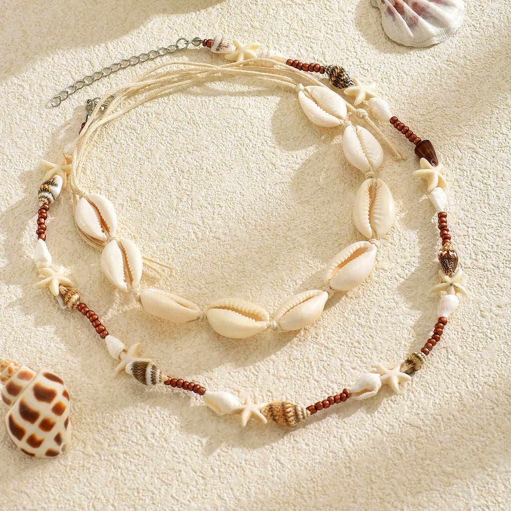 Handcrafted Bohemian shell necklace with geometric pendant on regular chain