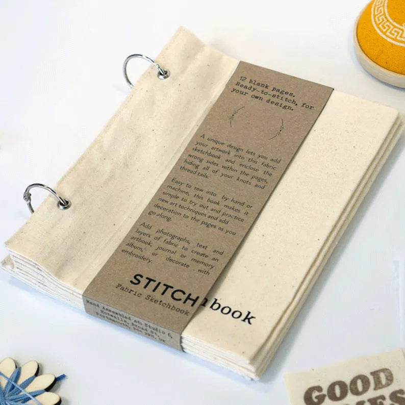 Linen stitch fabric sketchbook in beige square format with ring binding and waist seal