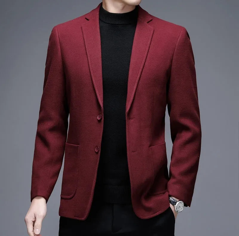 Man wearing a thick grey casual wool-style suit jacket with a loose fit and round hem.