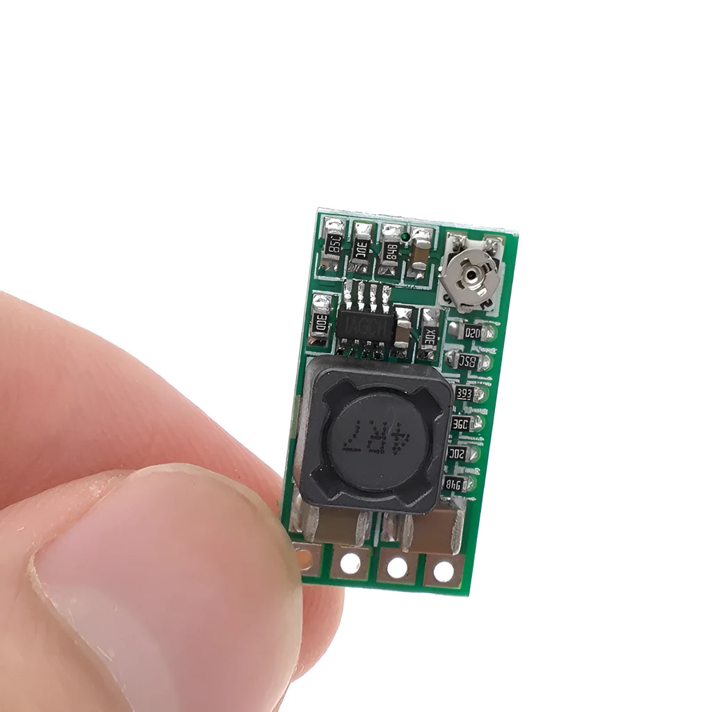 Green PCB mini DC-DC step down power supply module converting 12-24V to 5V 3A.