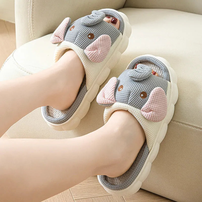 Elephant grey linen open-toe slippers for couples on a plain background, showing hand-sewn PVC sole.