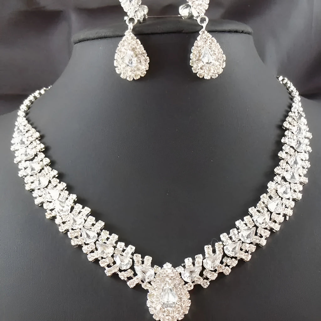 Gold bride wedding accessories set with drop earrings and necklace on white background
