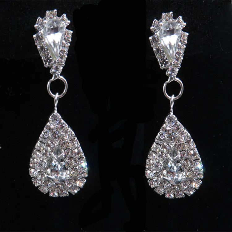 Gold bride wedding accessories set with drop earrings and necklace on white background