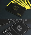 Stack of 10x15 cm custom printed logo cards with double-sided lamination showing brand information.