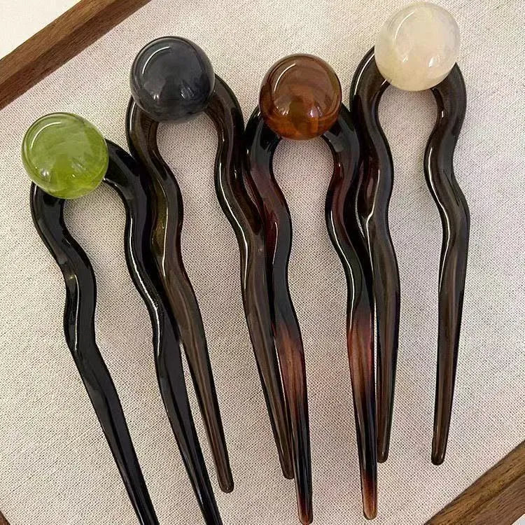 Acrylic U-shaped hair pin barrettes with retro ball decoration in beige, caramel, dark gray, and green colours.