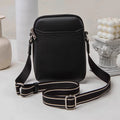 Solid colour small PU crossbody shoulder bag for mobile phones on a strap.