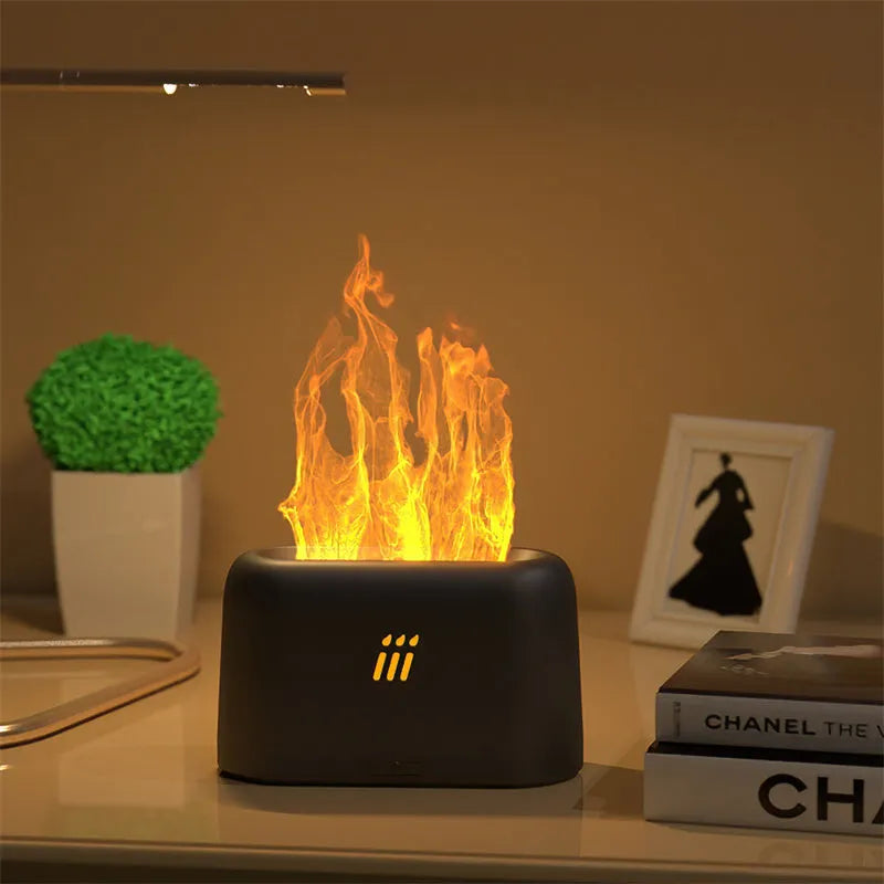 Black round ultrasonic aroma diffuser and humidifier with LED lights and remote control on a table.