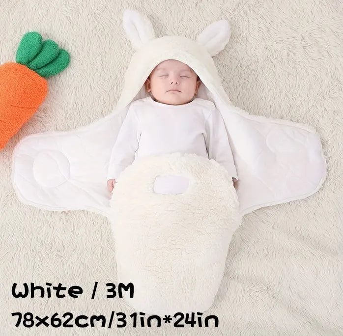 Baby wearing a grey adjustable fleece swaddle sleep sack with velcro wings