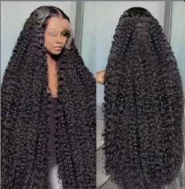 A woman wearing a long curly black synthetic lace wig with side bangs in a small roll wound tube Afro style.