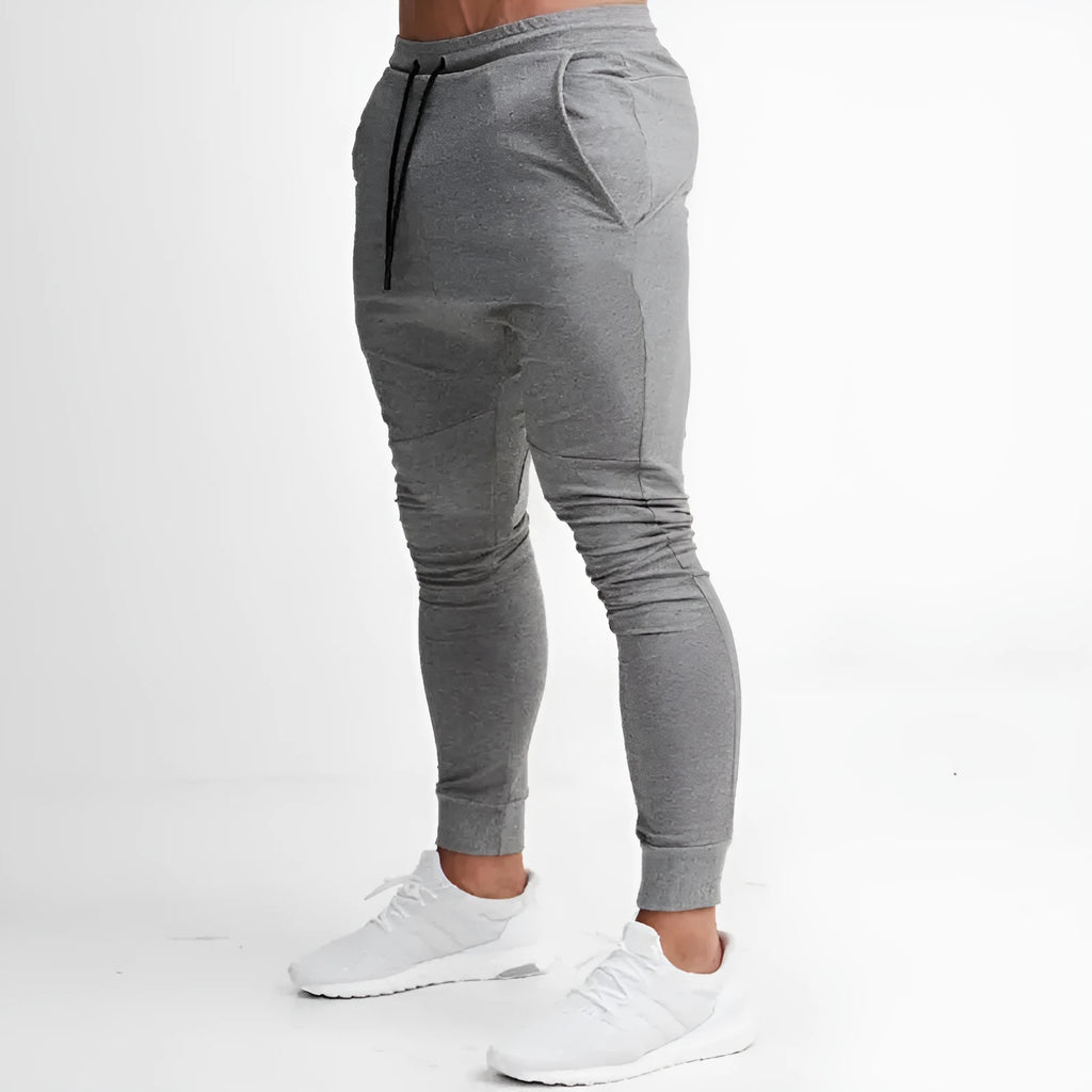 Men's slim fit gym pants in black with elastic waistband, available in multiple colours and sizes