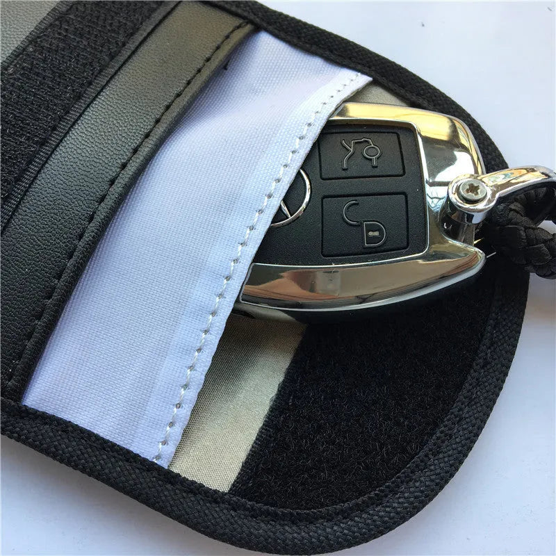 Black signal-blocking Faraday pouch for car key fobs, size 20x10 cm, lying flat on a surface