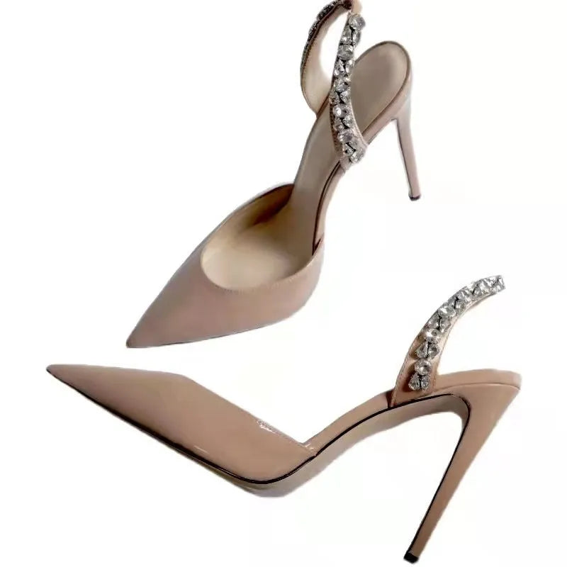 Women's black patent leather pointed toe high heel sandals with rhinestone decoration on the side.