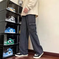 Man's grey straight-leg loose-fit jeans with flanging pocket design on a neutral background.