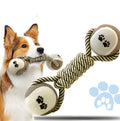 Cotton braided rope dumbbell dog toy with two tennis ball knots on a white background
