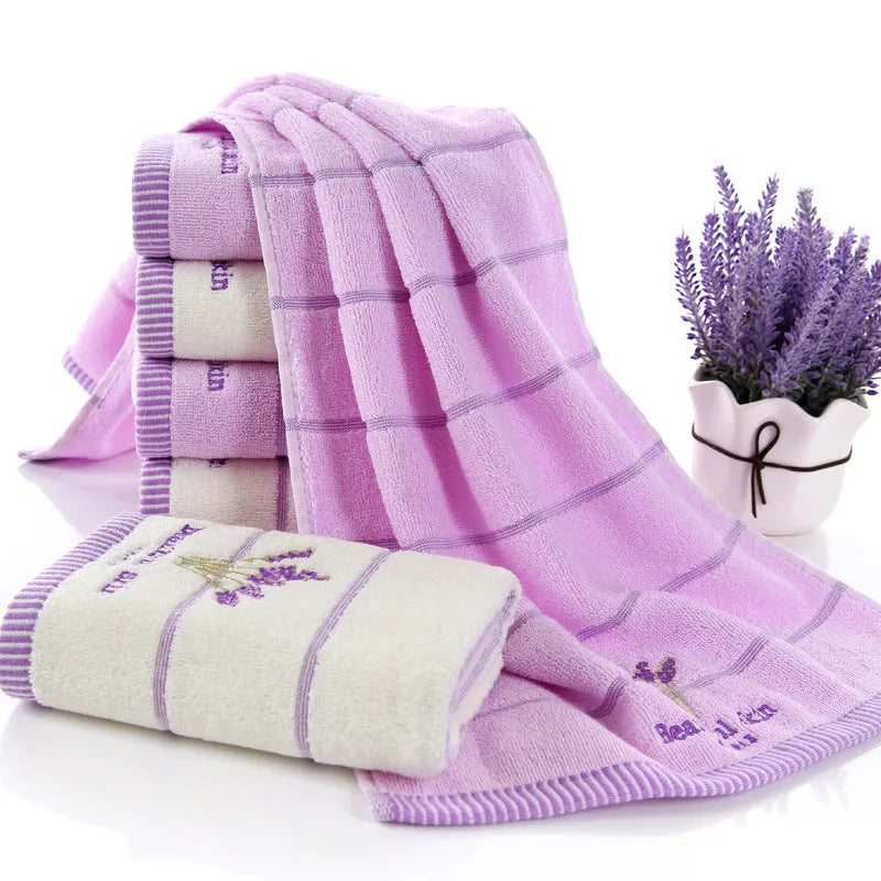 Pure cotton 32 strand embroidered face washing towel in green, 34x74cm, folded on a surface
