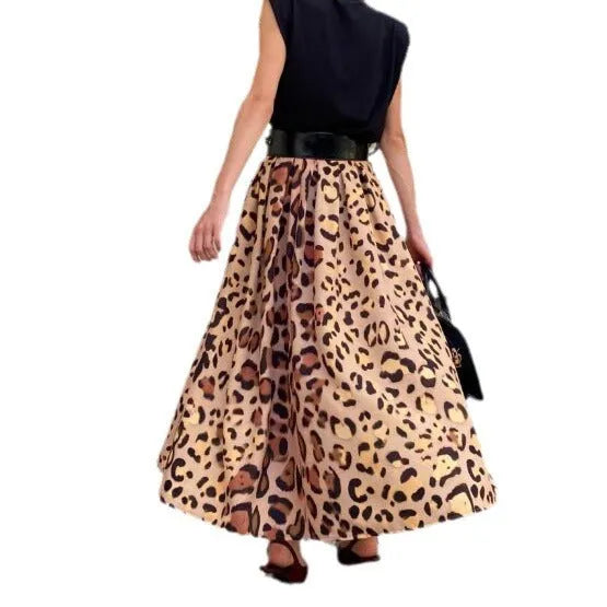Brown leopard print women's long A-line skirt with a wide flowing hem, shown on a hanger.