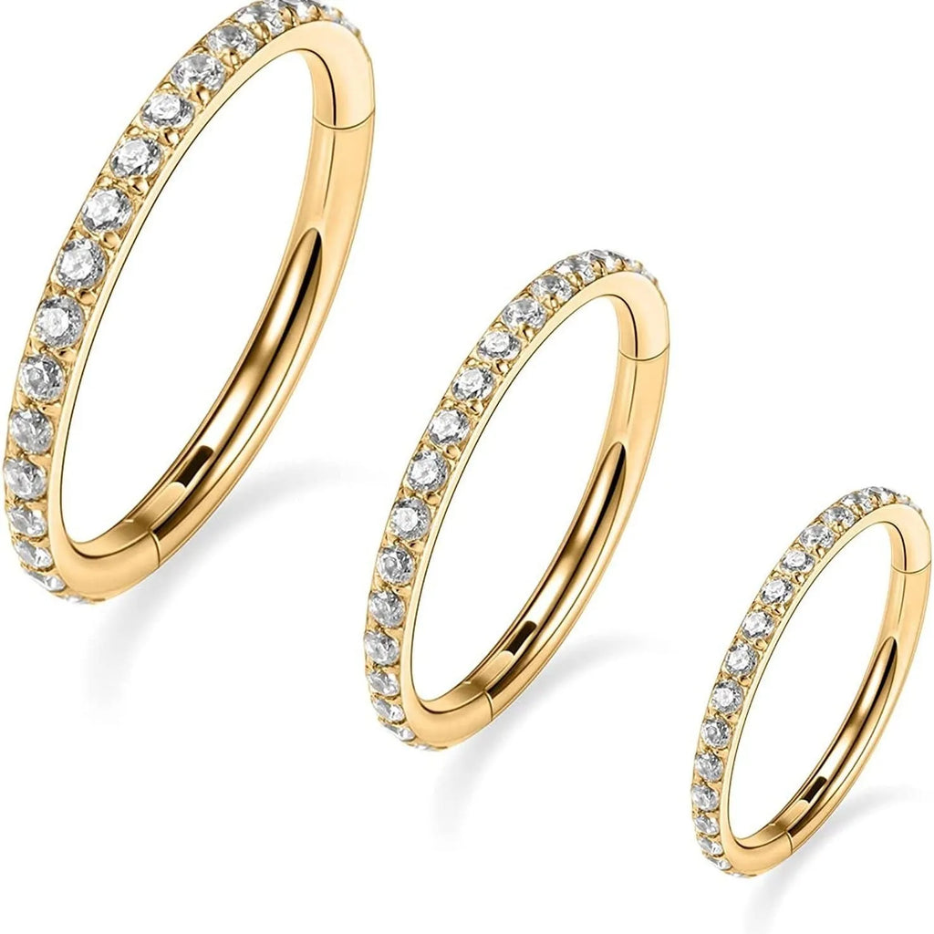 Seamless stainless steel nose ring with a central diamond decoration, shown in gold and rose gold finishes.