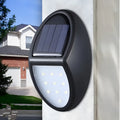 Black rectangular solar-powered LED wall light for outdoor garden use.