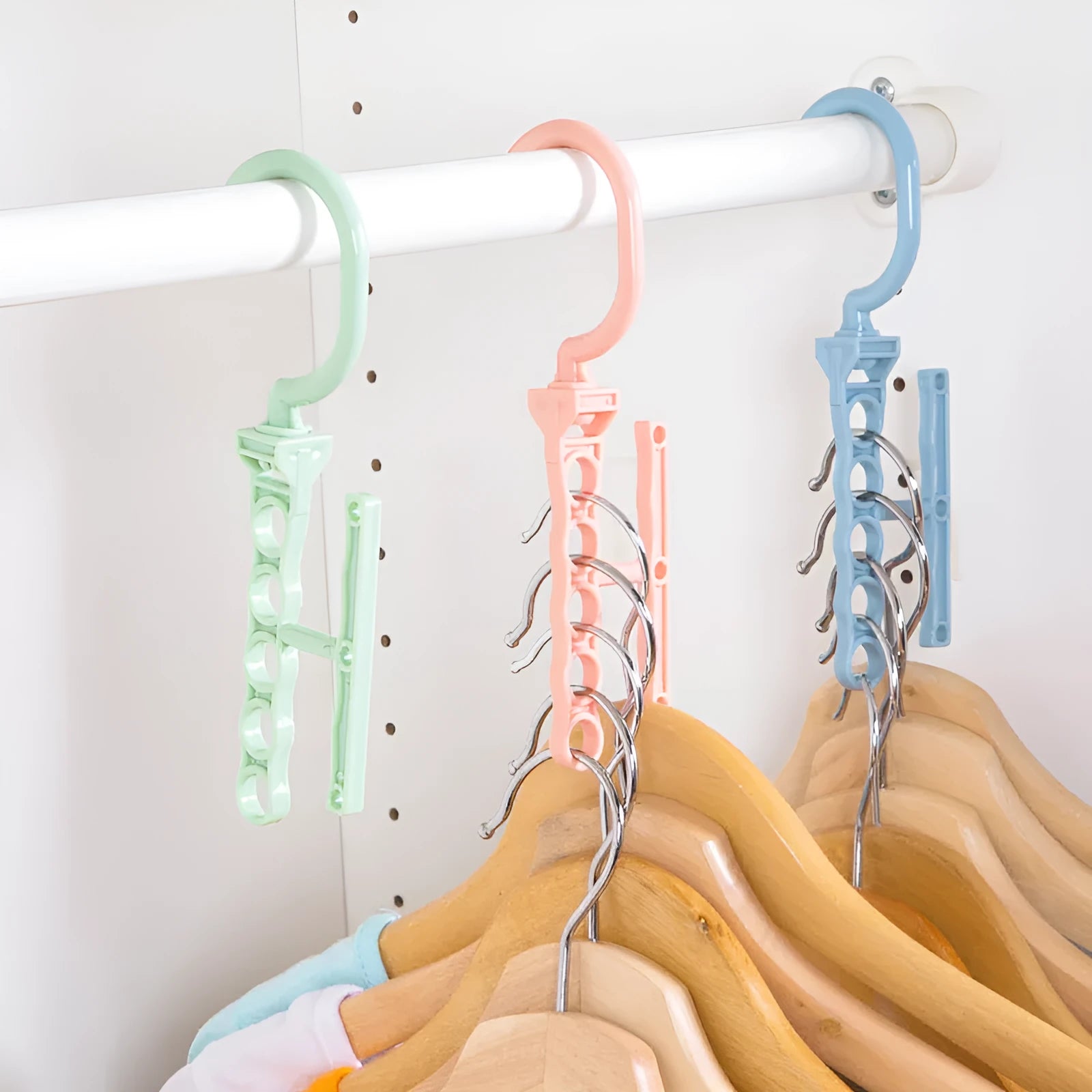 Blue revolving plastic wardrobe hanger with five branches and a central handle.