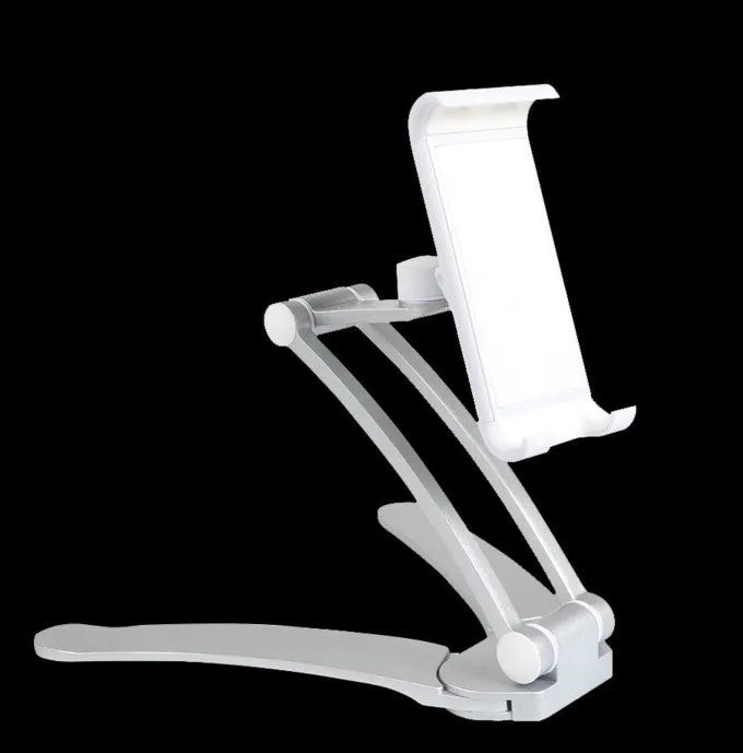 Silver aluminium desktop stand holding a tablet, showing 360-degree rotation and adjustable clamp mechanism.