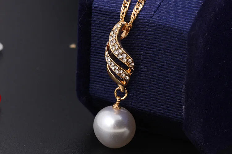Pearl stud necklace set with mother-of-pearl pendant on water wave chain in gold finish