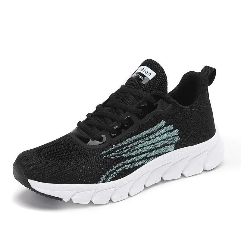 Women's black and white low-top running sneakers with cross strap design and MD soles