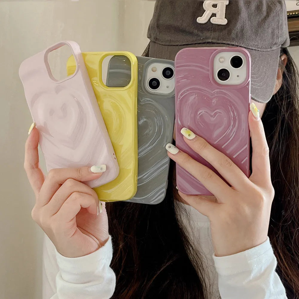 Solid colour iPhone case with a three-dimensional raised heart design on a glass back with TPU bumper.