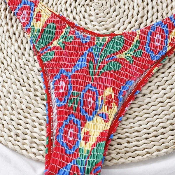 Red floral patterned women's underwire triangle bikini top and briefs on a mannequin.
