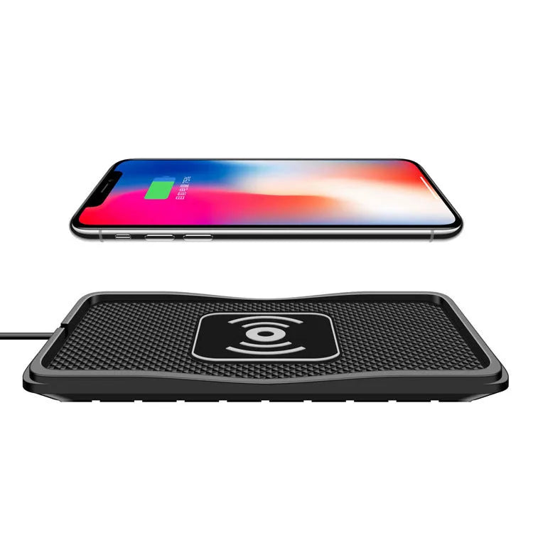 Black universal wireless car charger mount on a car air vent, charging a smartphone.