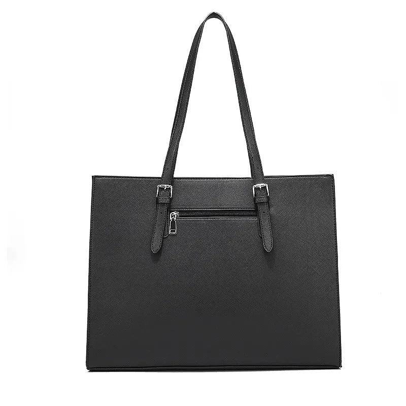 Large black business laptop bag showing multiple internal organisers and three shoulder strap options for women's daily commuting