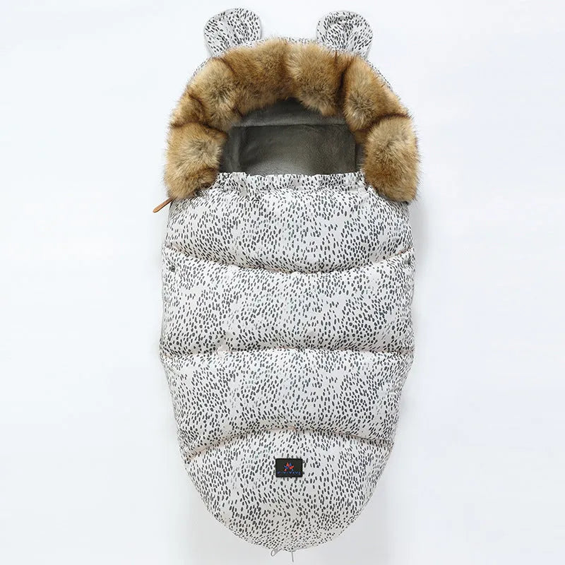 Baby warm cocoon style sleeping bag on a neutral background demonstrating solid colour design with zip closure