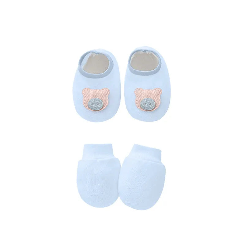 Set of white, light blue, and grey cotton baby pullover caps, gloves, and foot covers for infants.