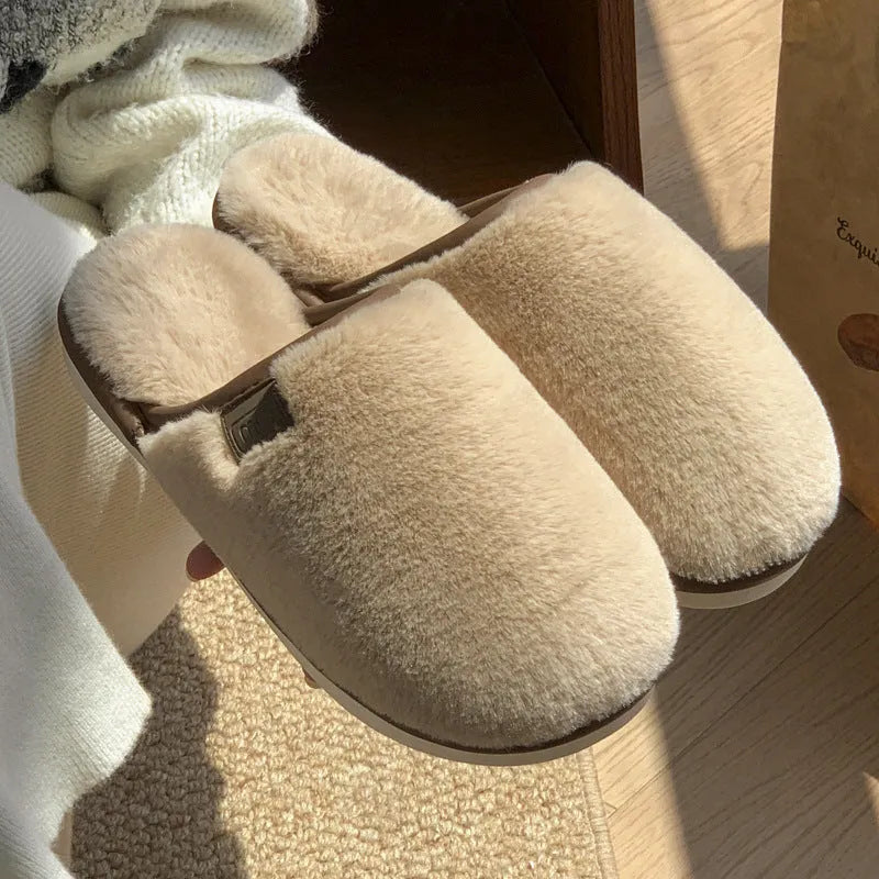 Solid colour plush slippers with PVC non-slip sole and car stitching detail on the upper.