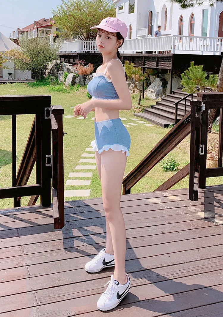 Solid colour conservative one-piece swimsuit for women with suspender straps.