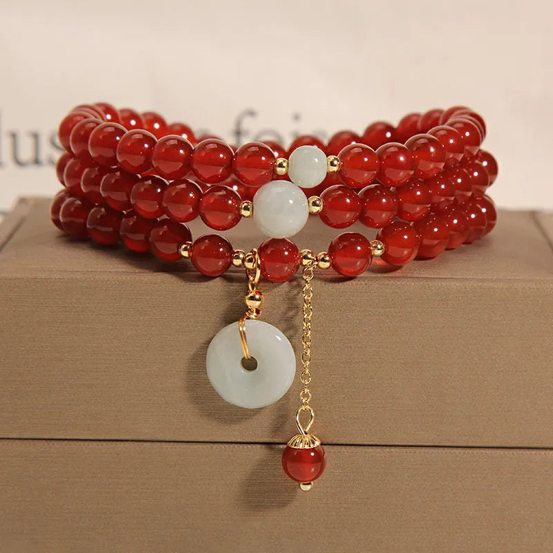 Red agate multi-layer crystal bracelet with a retro ethnic style on a white background.