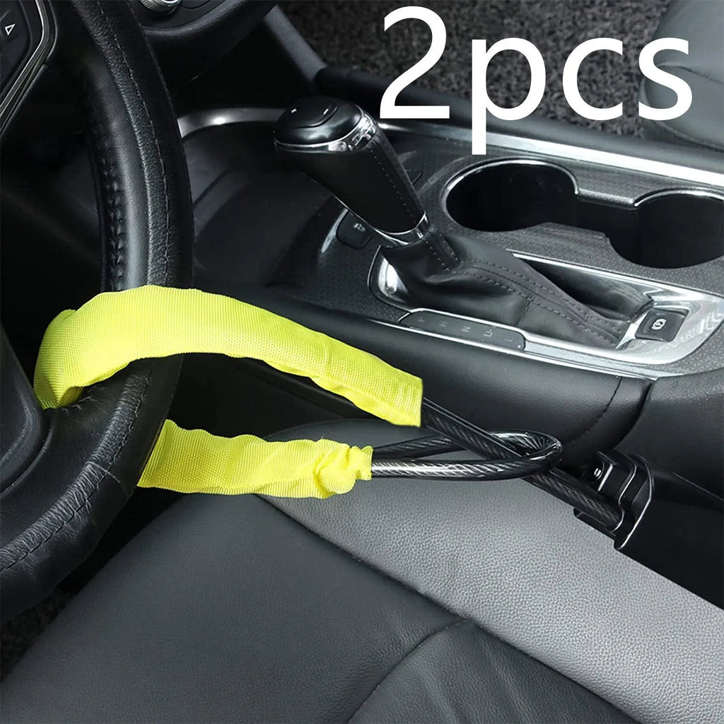 Red iron car steering wheel lock with brass core for General Motors vehicles on a steering wheel.