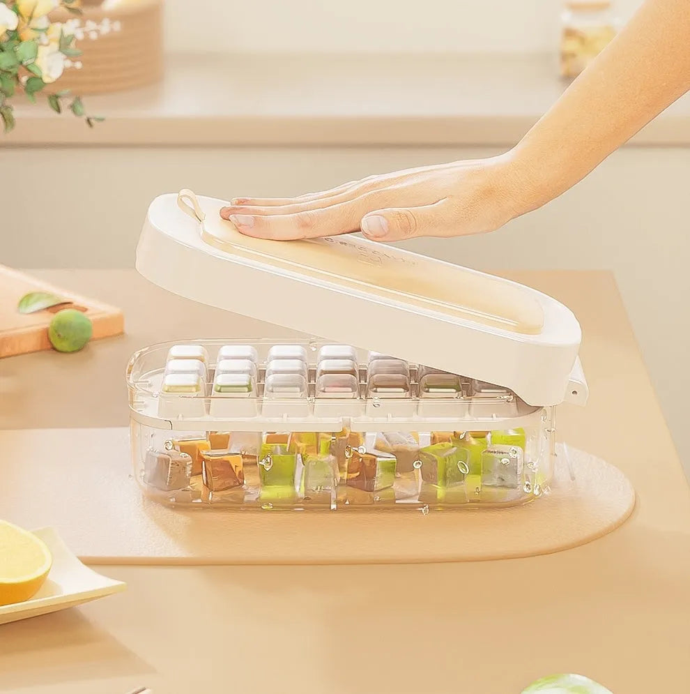 Colourful plastic ice cube tray with a lever and a built-in slot for an ice shovel.