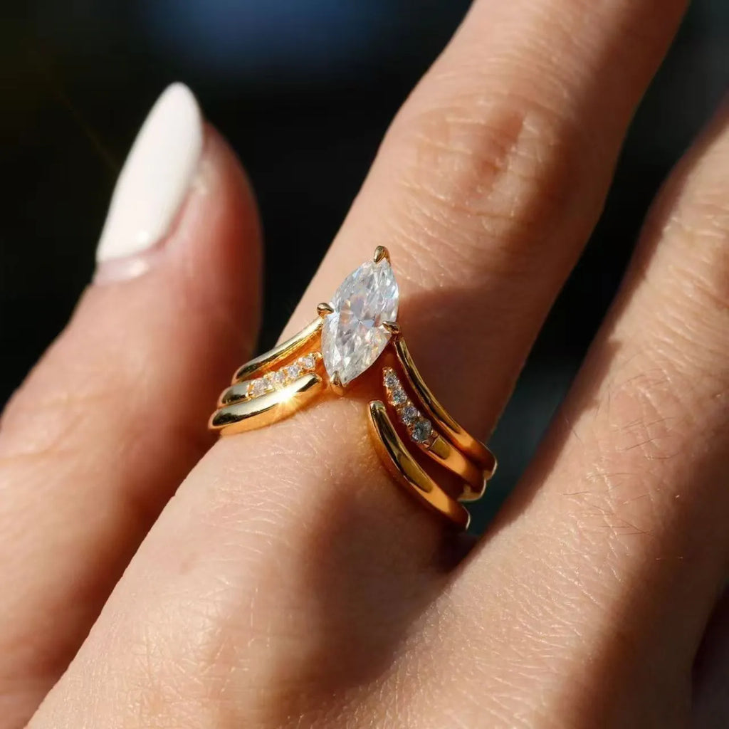 Gold zinc alloy three-piece geometric ring set with horse eye inlay on white background