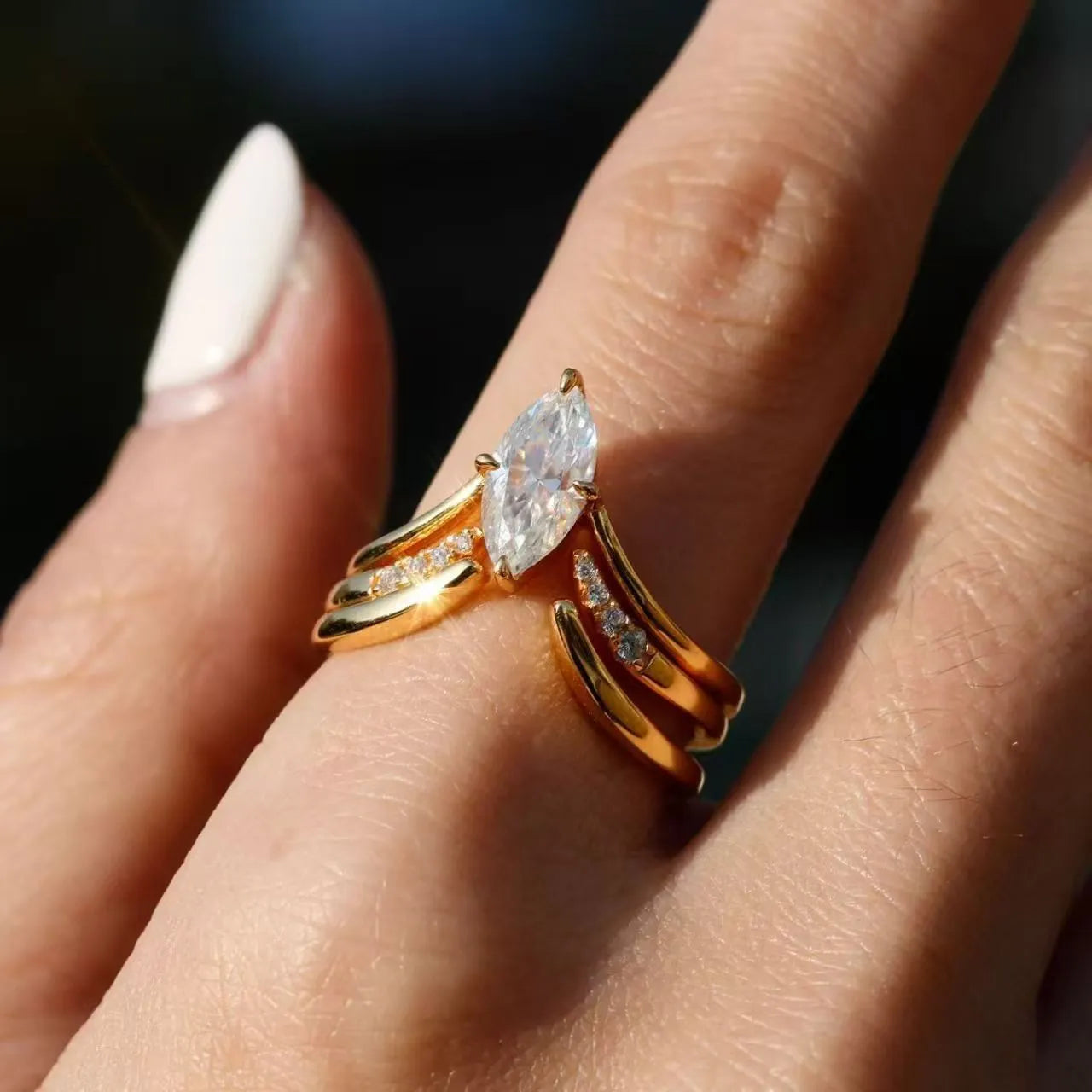 Gold zinc alloy three-piece geometric ring set with horse eye inlay on white background