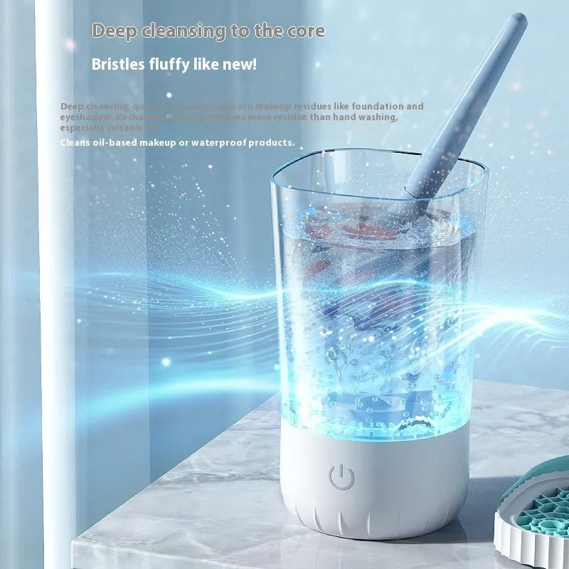 White rechargeable electric makeup brush cleaning device with USB cable.