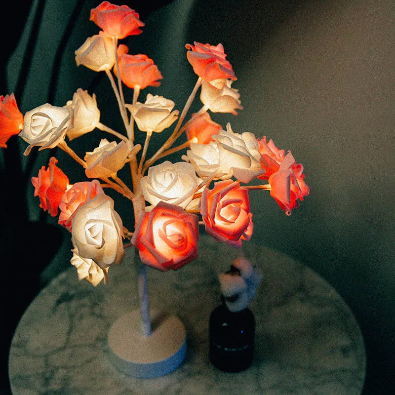 White and red rose flower shaped USB battery LED table lamp with warm white light on a table