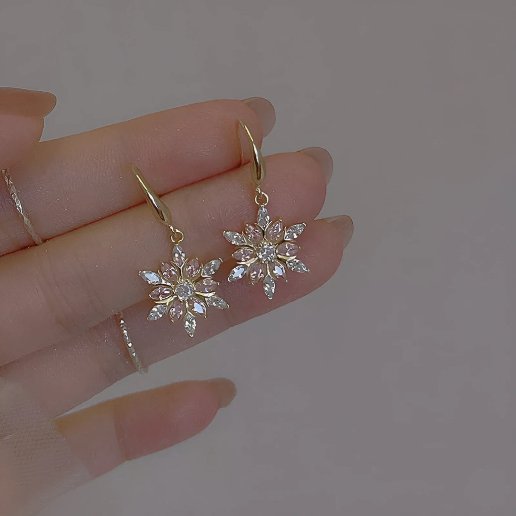 Gold alloy snowflake earrings with central zircon stone for women