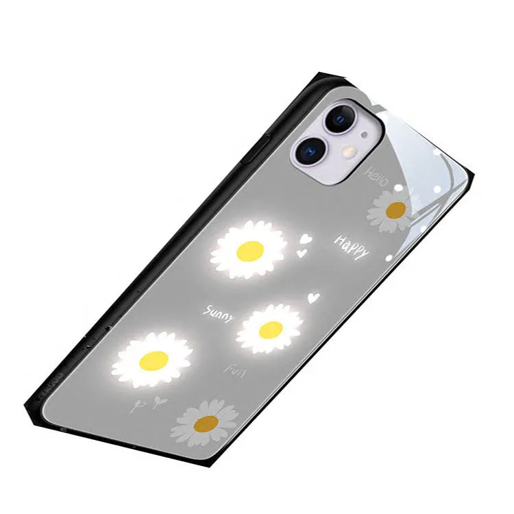 Luminous purple and white daisy iPhone case with voice-activated colour lights on a phone.