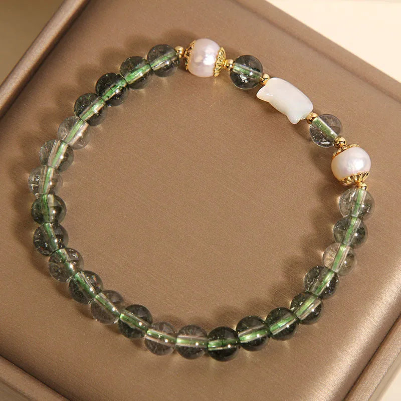 Green Phantom Quartz crystal bracelet with a detailed Shell Kitten charm on a women's wrist.