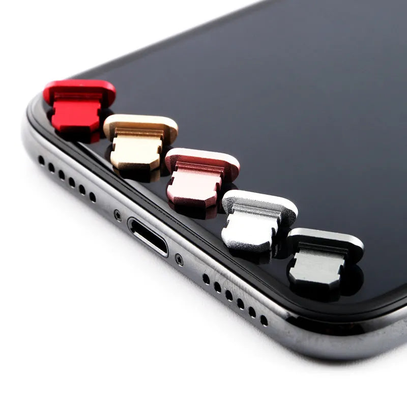 Aluminium alloy charging port dust plug for iPhone in various metallic colours including gold and rose gold.