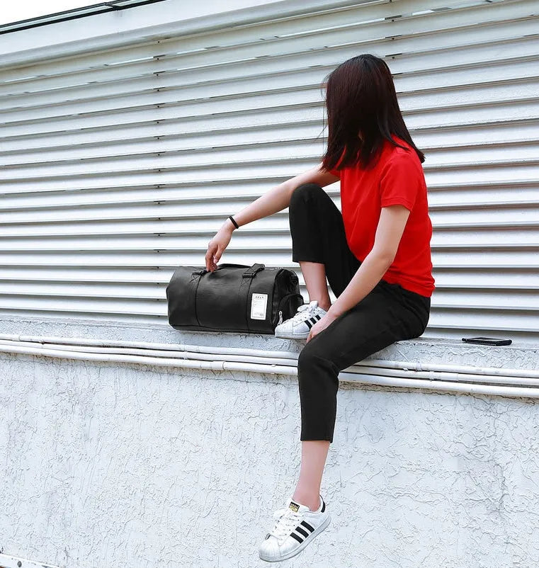 Black unisex waterproof sports bag with a separate shoe compartment and diagonal straps.