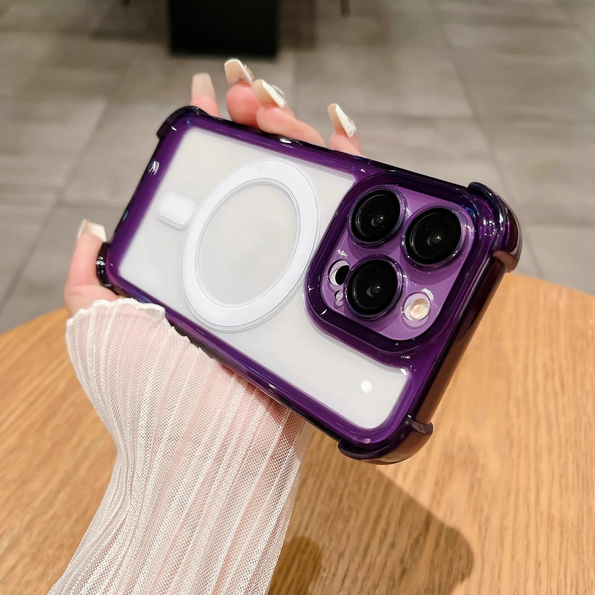 Transparent silicone airbag phone case for iPhone with magnetic ring and built-in camera lens protection.