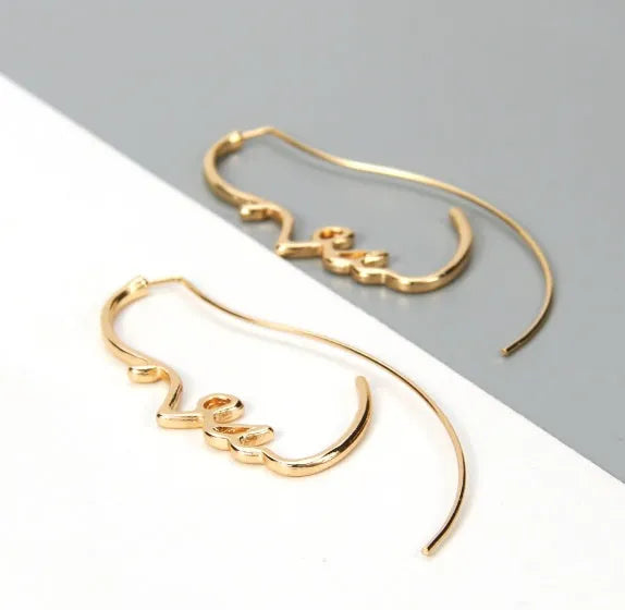 Creative abstract face contour earrings in gold and silver metal finishes, 75 by 35mm