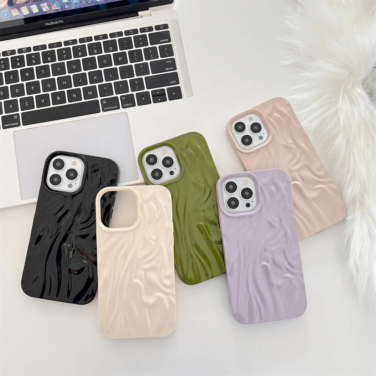 Solid colour water ripple texture silicone phone case for iPhone, shown in milky white, pink, and purple colour options.
