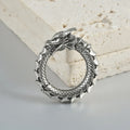Retro geometric dragon-shaped hollow out earrings in antique silver finish, shown from the front.